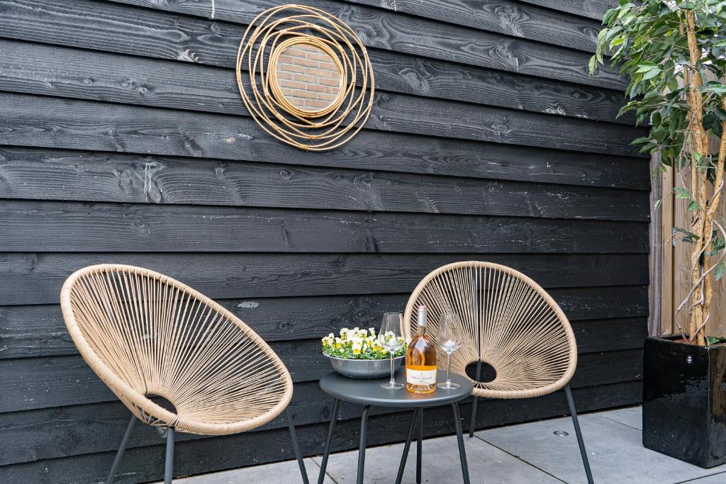 Private garden patio with rattan chairs at La Siesta